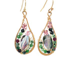 Pair of gold teardrop earrings with multicolored gemstones on a white background