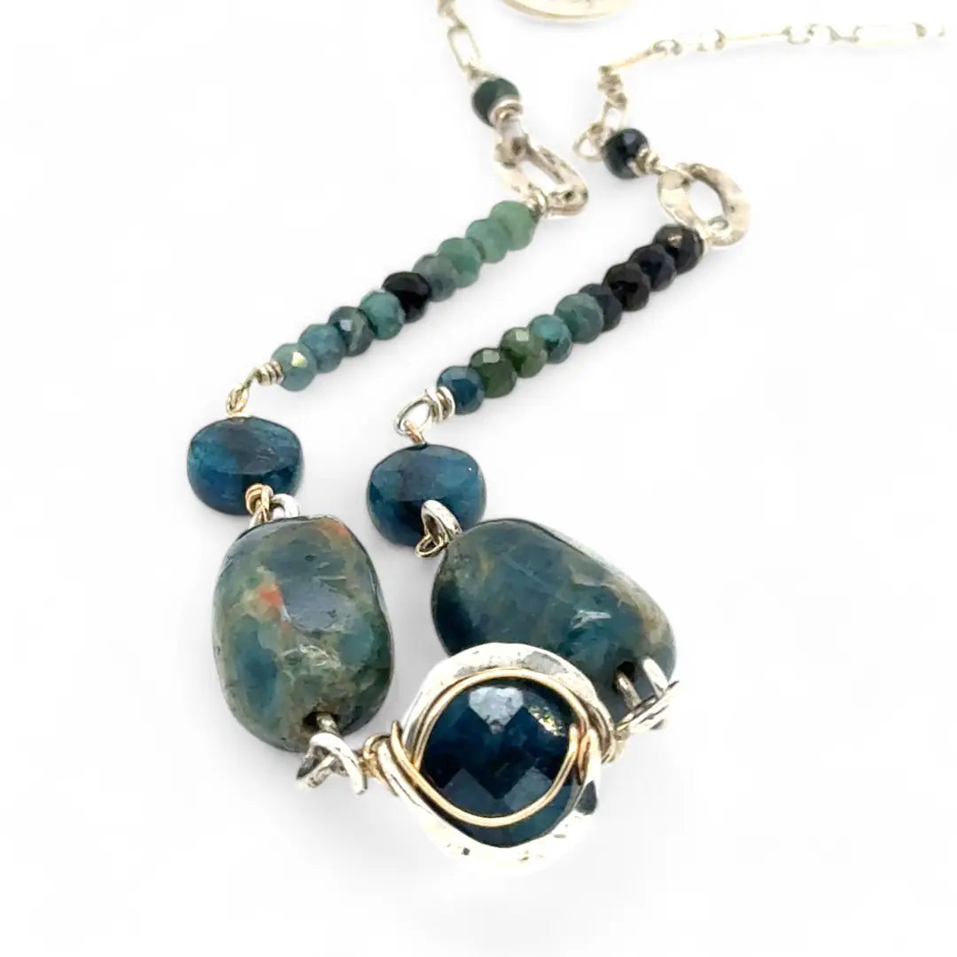 Necklace with blue and green beads on a white background