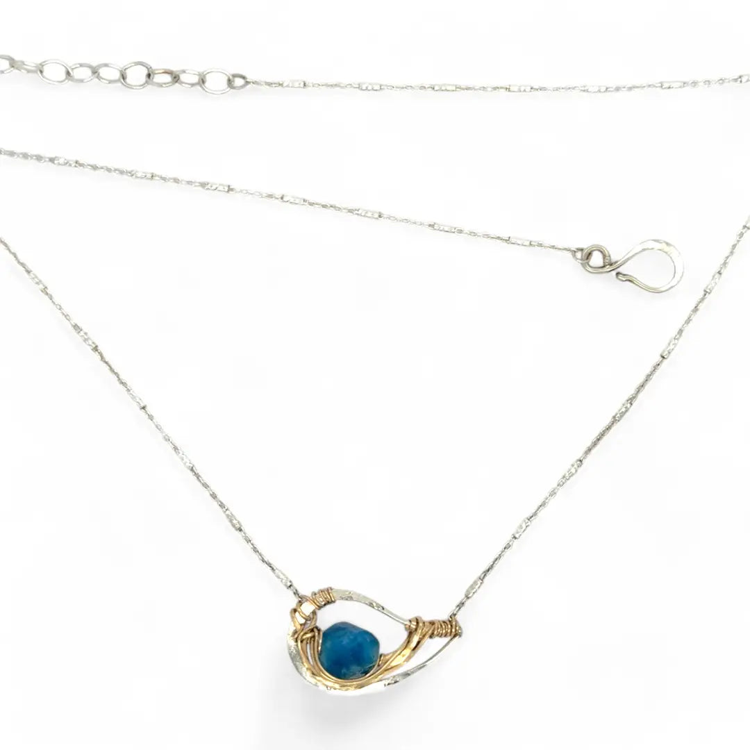 Necklace with a blue pendant on a white background