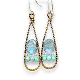 A pair of twisted brass drop earrings featuring blue crystal, amazonite and apatite gemstones