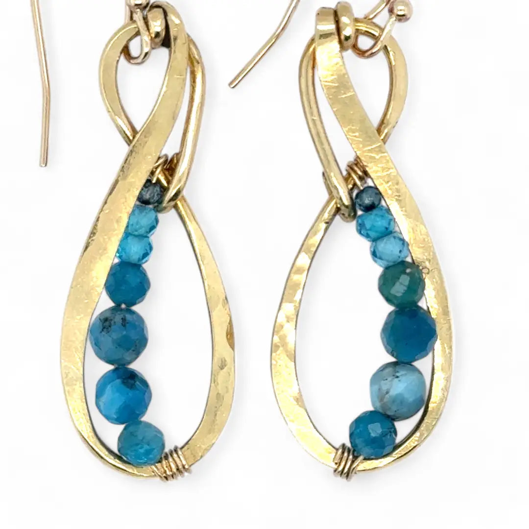 Gold earrings with apatite gemstone beads on a white background