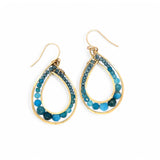 A pair of gold-filled bronze channel hoop earrings with blue apatite gemstones, featuring gold-filled French hooks.