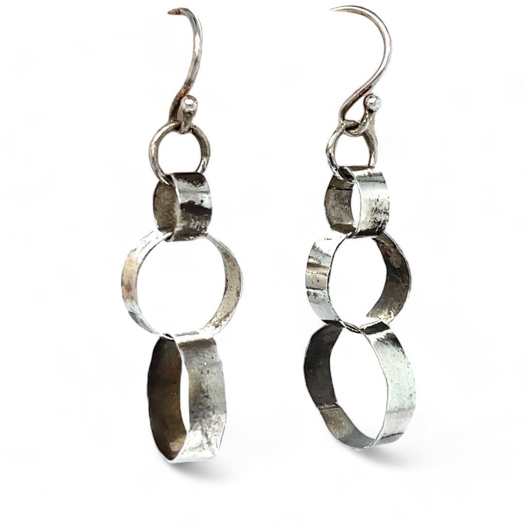 A pair of sterling silver hammered band ring earrings with French hooks.
