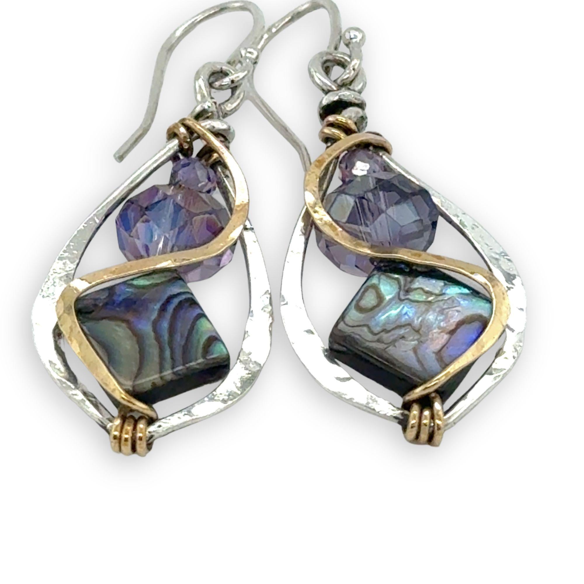 Pair of earrings with purple crystals and abalone gemstones on a white background