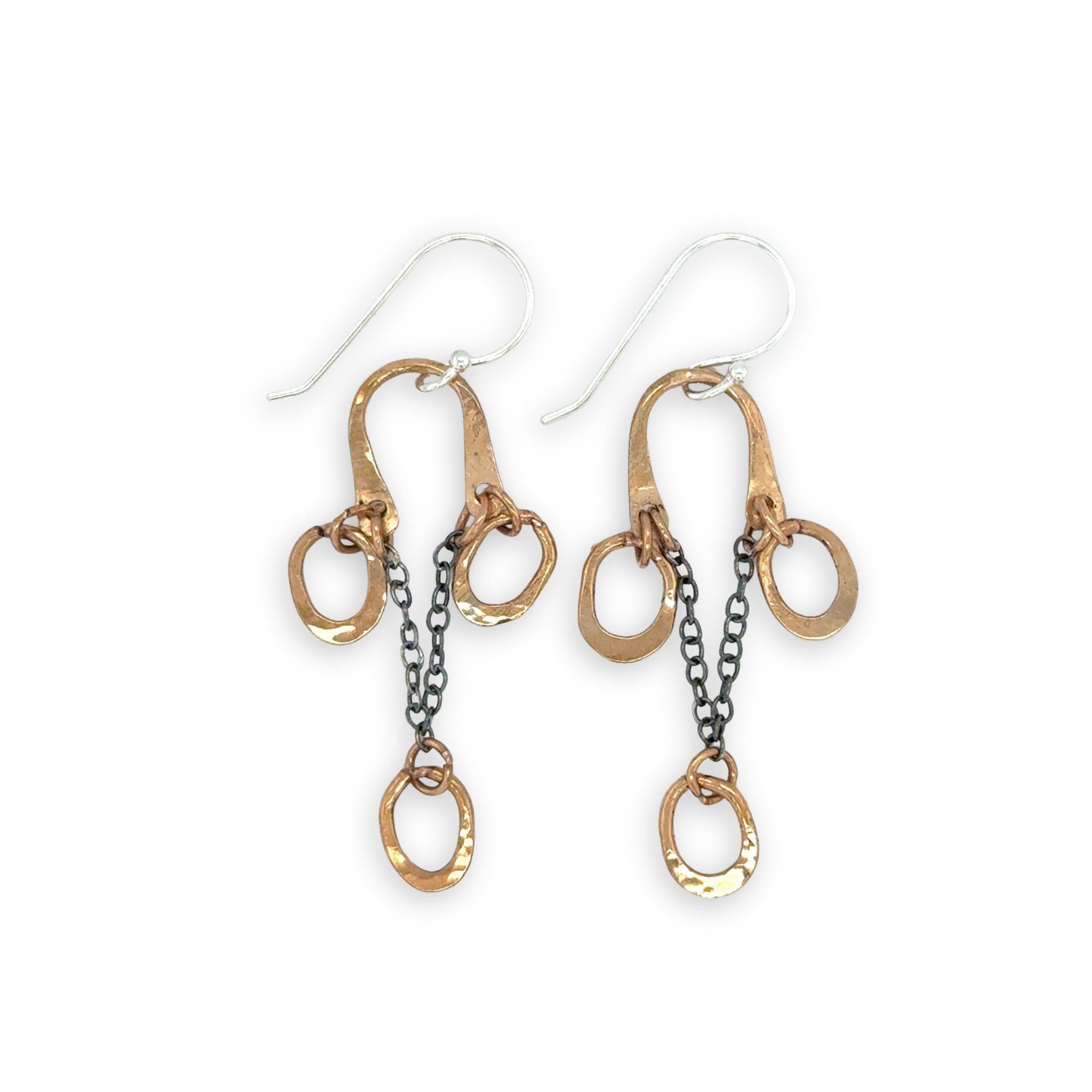 Gold and silver chain earrings on a white background