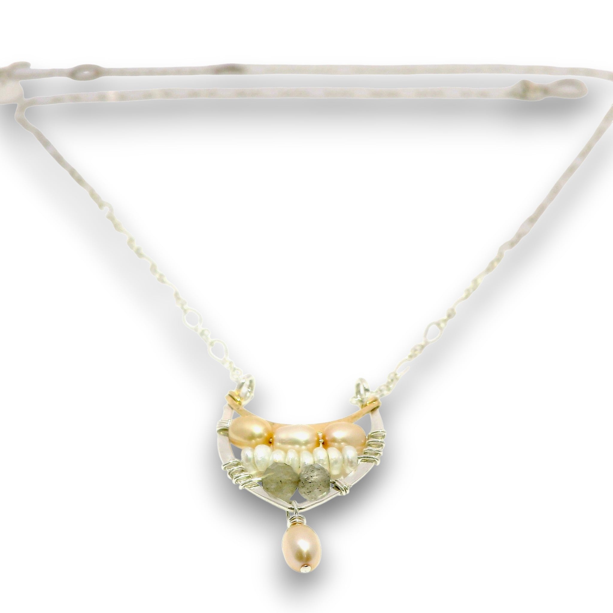 A delicate necklace with a crescent-shaped pendant featuring gold-toned metal, pale pearls, and green gemstone accents, suspended from a fine chain on a white background.