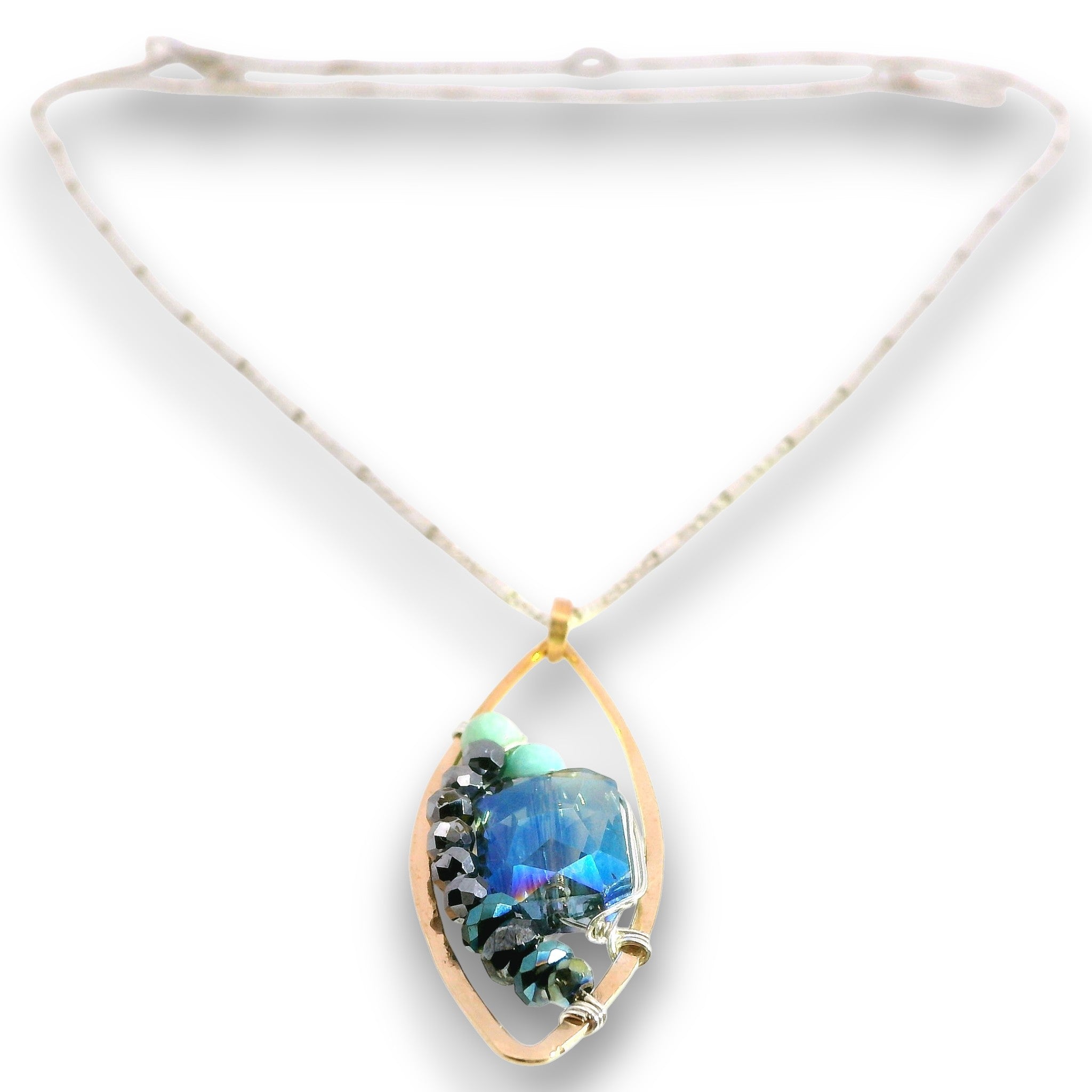 A gold teardrop pendant necklace featuring a central blue iridescent stone and black beads, suspended from a white cord on a white background.