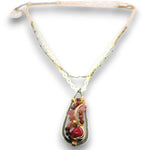 A handmade teardrop pendant necklace featuring a silver-toned metal frame filled with small pinkish-red beads and gold-toned wire wrapping, suspended from a delicate gold chain.