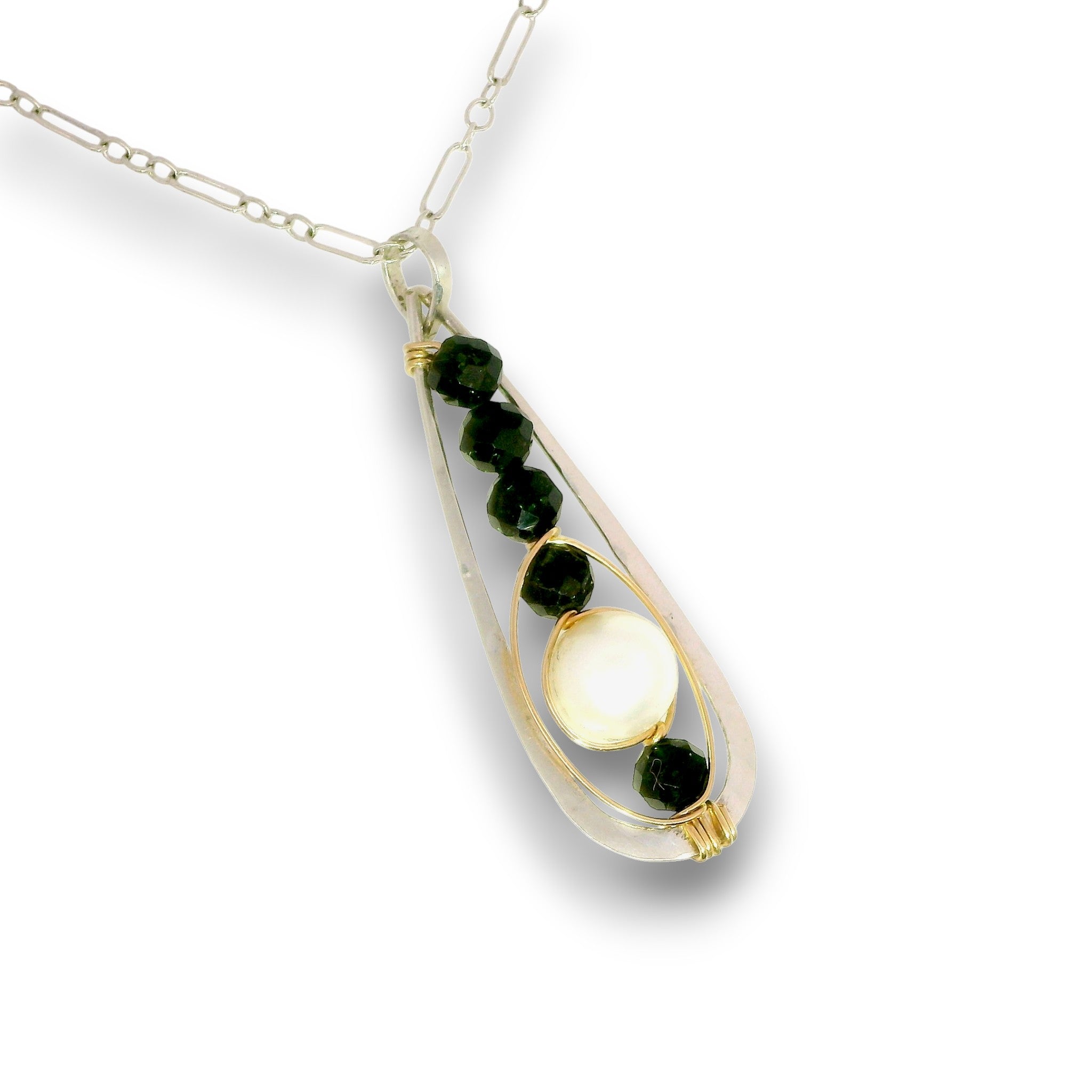 A teardrop-shaped pendant necklace featuring a silver-toned chain, a clear glass or resin outer frame, dark green faceted gemstones, and a central white cabochon stone with a gold accent.