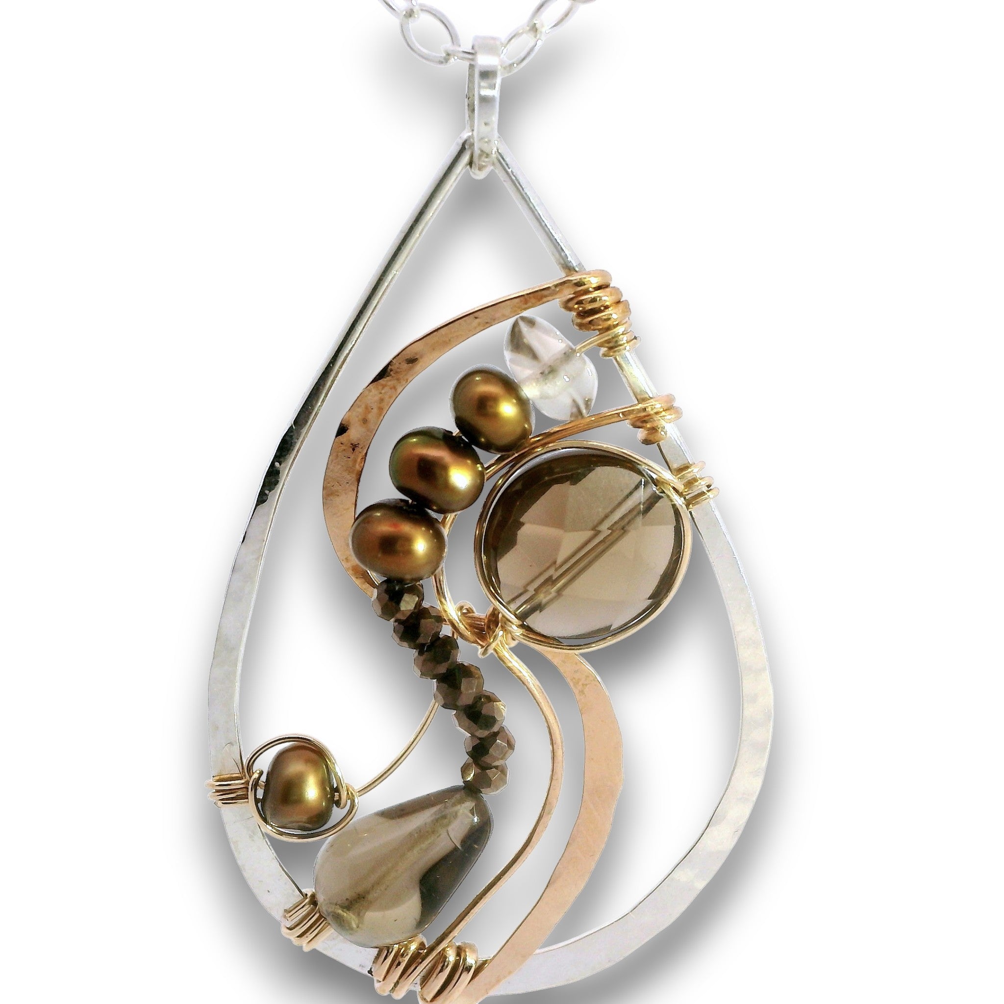 A teardrop-shaped pendant necklace featuring a polished silver-tone frame, curved rose gold-tone bands, brown pearl-like beads, a smoky brown glass bead, and a small clear crystal on a white background.