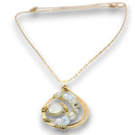 A gold chain necklace with a crescent-shaped pendant featuring light blue gemstone beads and a central round white stone, displayed on a clean white background.