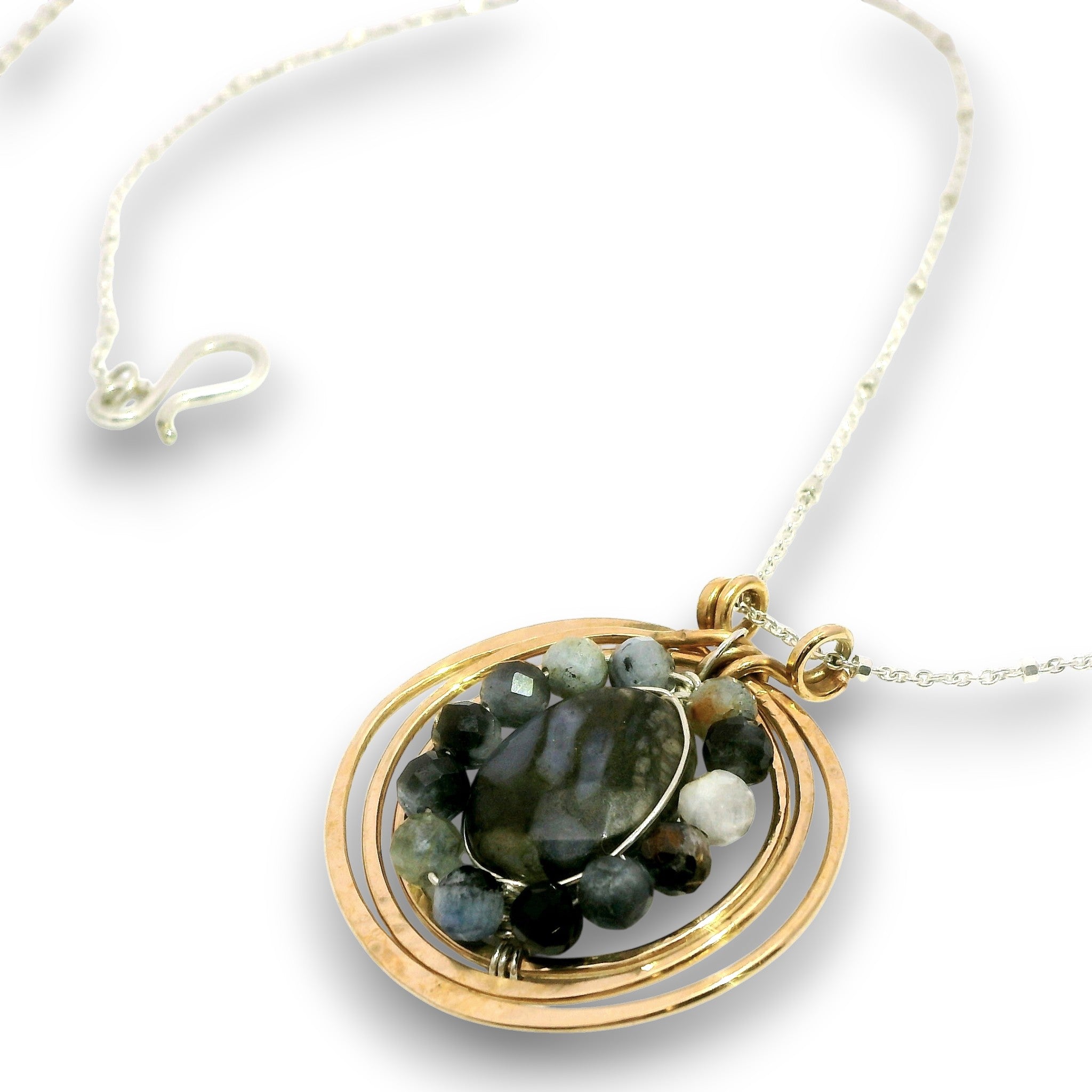 A gold and silver wire-wrapped pendant necklace featuring a faceted dark green labradorite stone and small accent beads, shown on a clean white background.