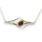 Sterling silver pendant with smoky quartz rectangle with silver and gold-filled curves on delicate silver chain.