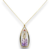 A gold pendant necklace featuring a teardrop-shaped bezel set with a purple amethyst crystal and a small round pink stone, suspended from a delicate gold chain against a white background.