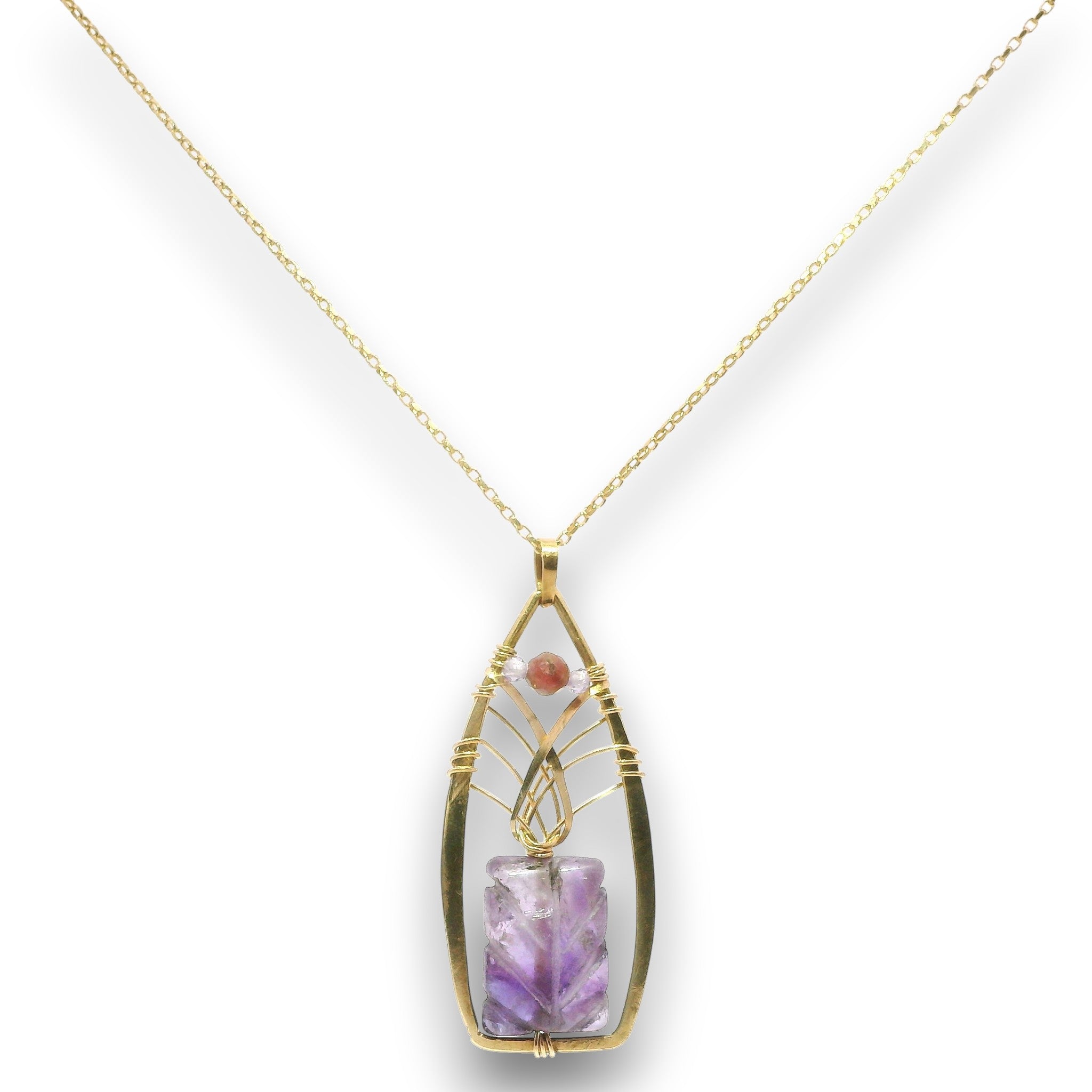 A gold pendant necklace featuring a teardrop-shaped bezel set with a purple amethyst crystal and a small round pink stone, suspended from a delicate gold chain against a white background.