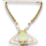 A beaded necklace with a central pale green teardrop pendant, suspended between two interlocking gold wire triangles. The necklace features small metallic gold beads and clear faceted beads on a white background.