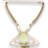 A beaded necklace with a central pale green teardrop pendant, suspended between two interlocking gold wire triangles. The necklace features small metallic gold beads and clear faceted beads on a white background.