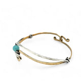 A sterling silver and brass hammered cuff bracelet featuring a single blue amazonite gemstone, with a twist design and an interlocked structure.
