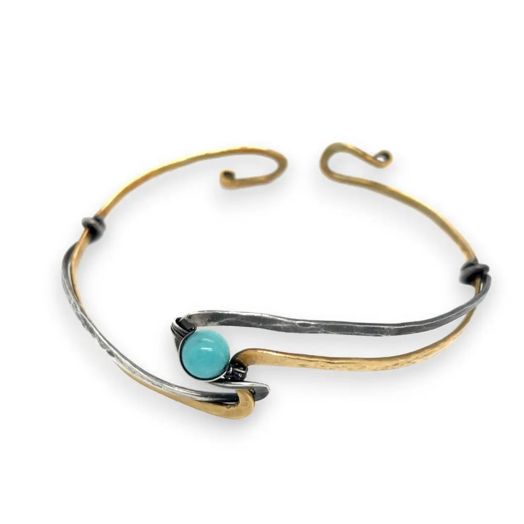 A sterling silver and brass hammered cuff bracelet featuring a single blue amazonite gemstone, with a twist design and an interlocked structure.