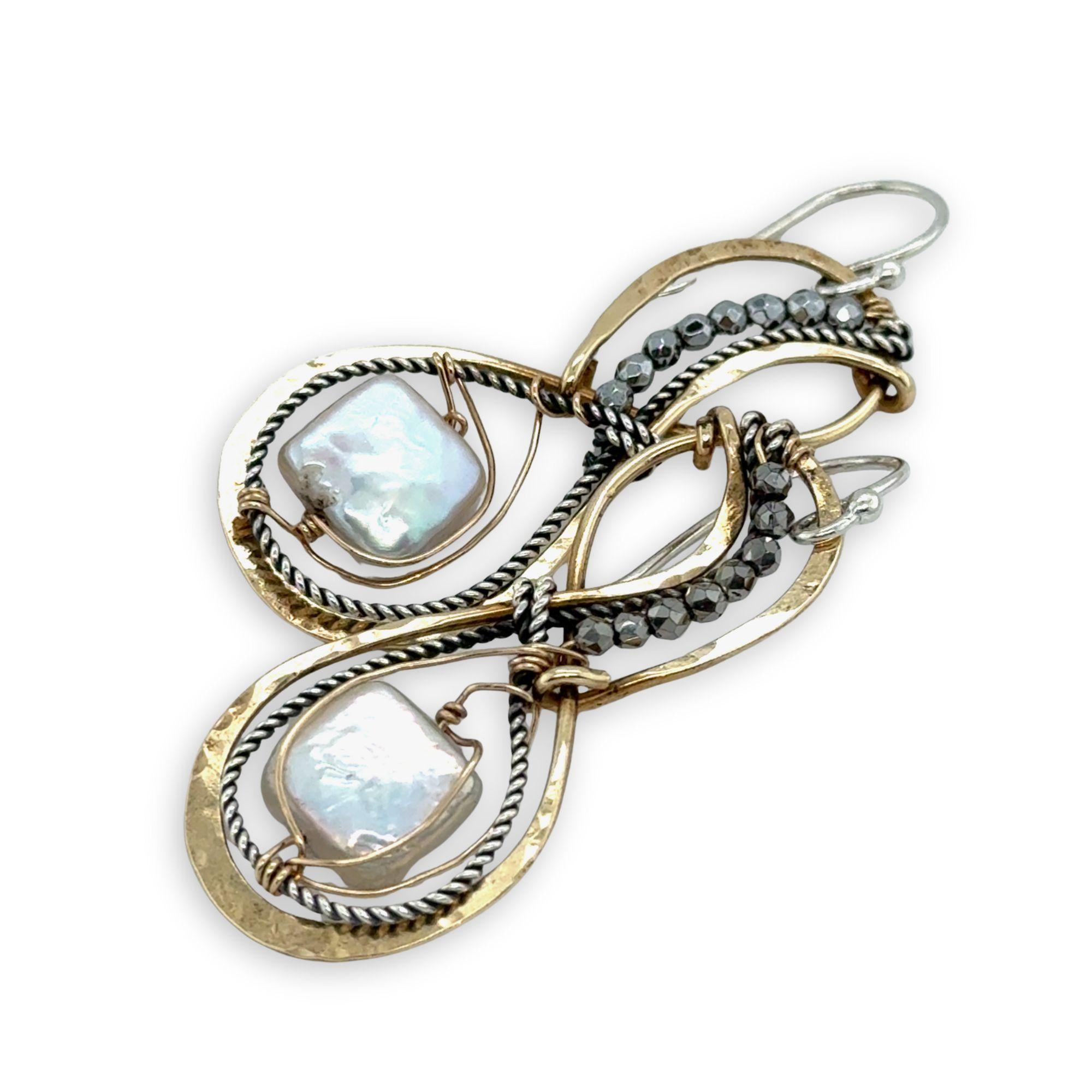 brass infinity shaped earrings are lined with oxidized sterling silver twist with pyrite and fresh water pearl tile accents