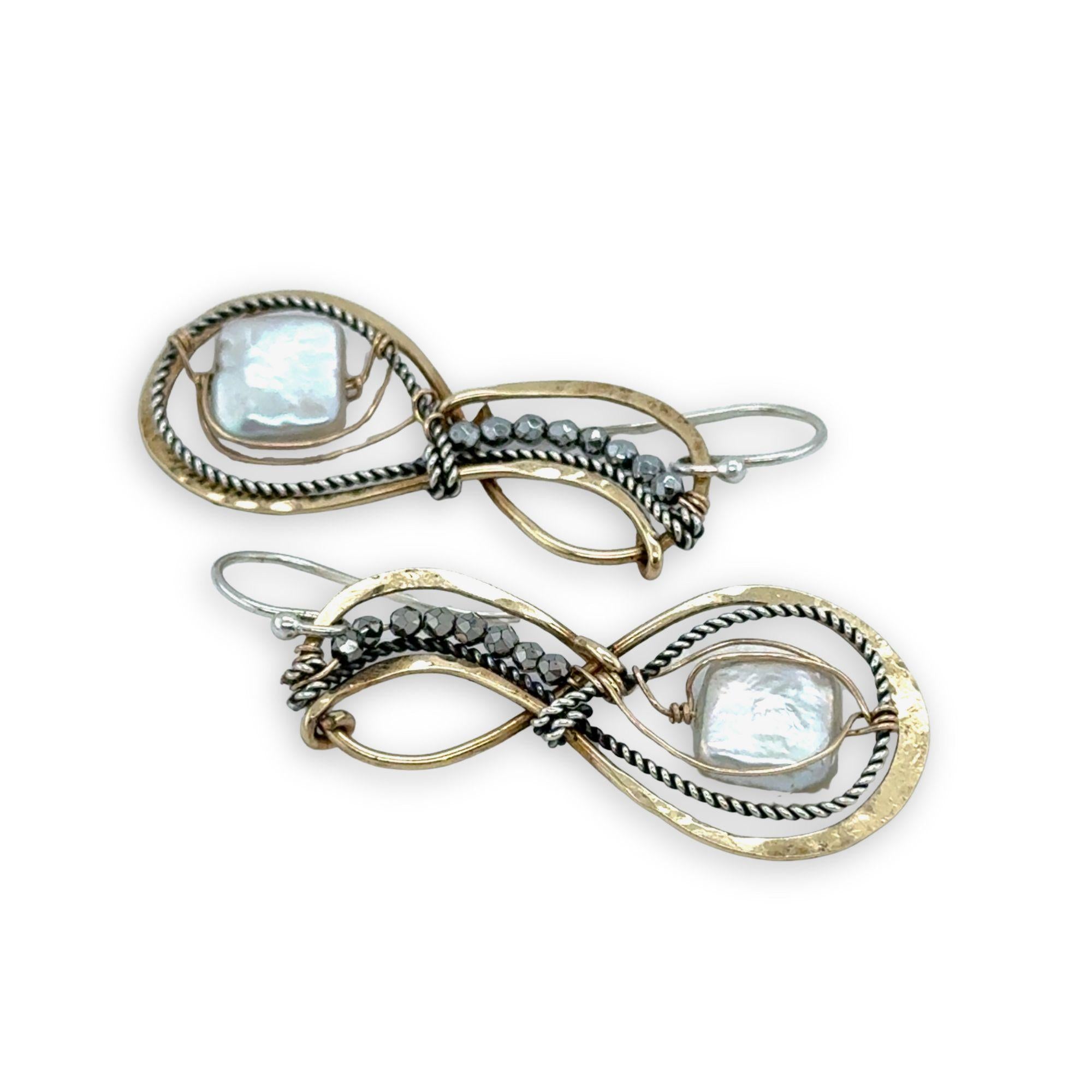 brass infinity shaped earrings are lined with oxidized sterling silver twist with pyrite and fresh water pearl tile accents