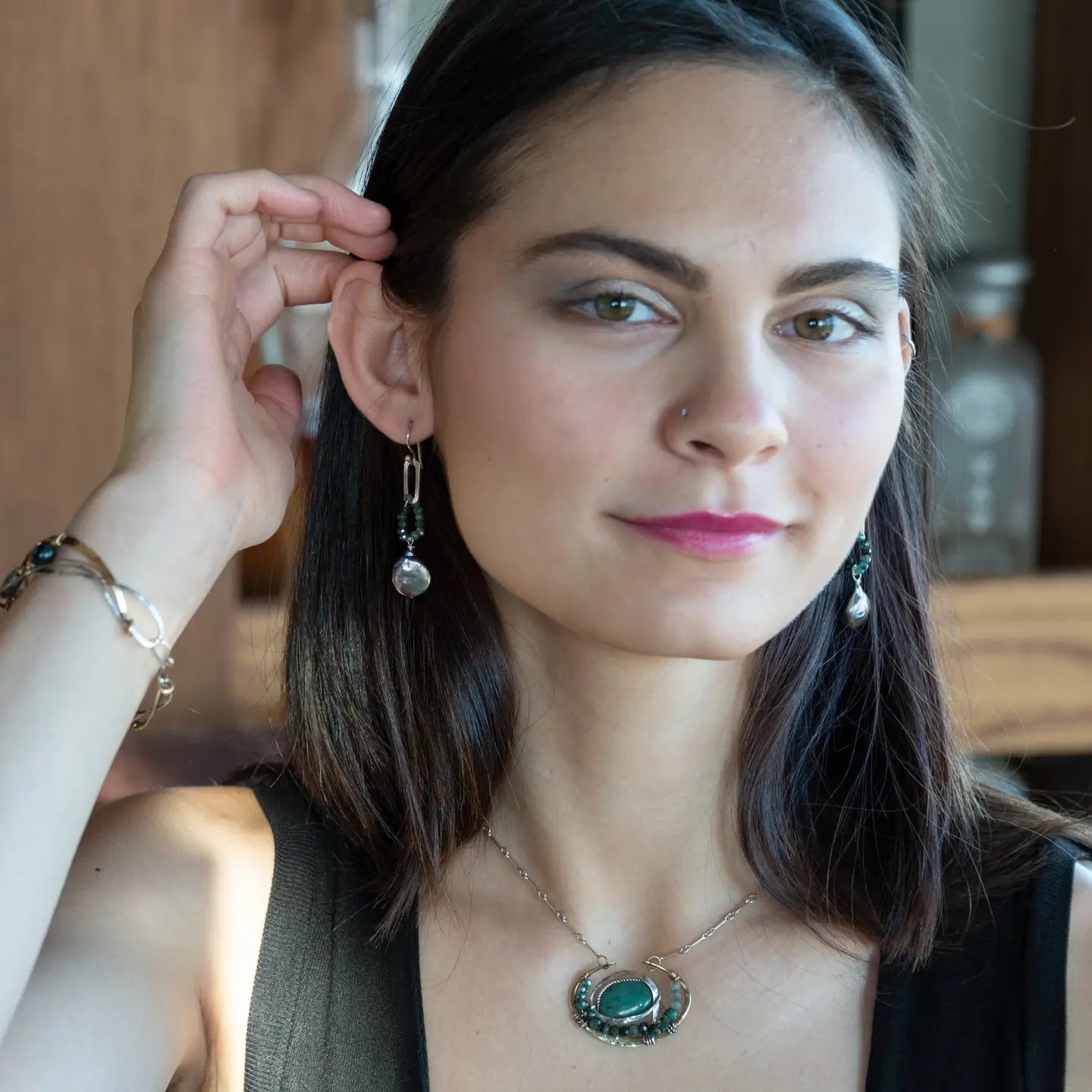  brass cup necklace with smooth african opal jasper oval wrapped in hammered sterling silver, oxidized sterling twist, emerald gemstones, and crystal