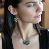  brass cup necklace with smooth african opal jasper oval wrapped in hammered sterling silver, oxidized sterling twist, emerald gemstones, and crystal