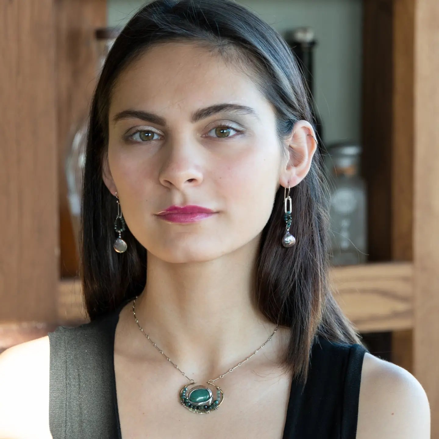  brass cup necklace with smooth african opal jasper oval wrapped in hammered sterling silver, oxidized sterling twist, emerald gemstones, and crystal