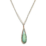 a smooth amazonite drop is wrapped tightly in apatite gemstones and sterling silver wire in a handmade hammered copper drop pendant hanging from a double gold filled and oxidized sterling silver chain necklace