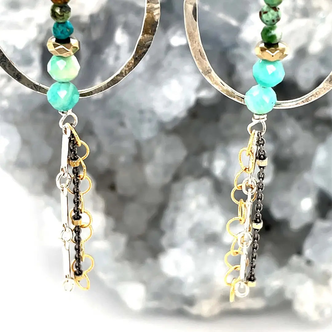 A pair of earrings featuring amazonite, turquoise, moonstone, and pyrite gemstones with gold filled and sterling silver chain shimmys