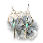 A pair of earrings featuring amazonite, turquoise, moonstone, and pyrite gemstones with gold filled and sterling silver chain shimmys