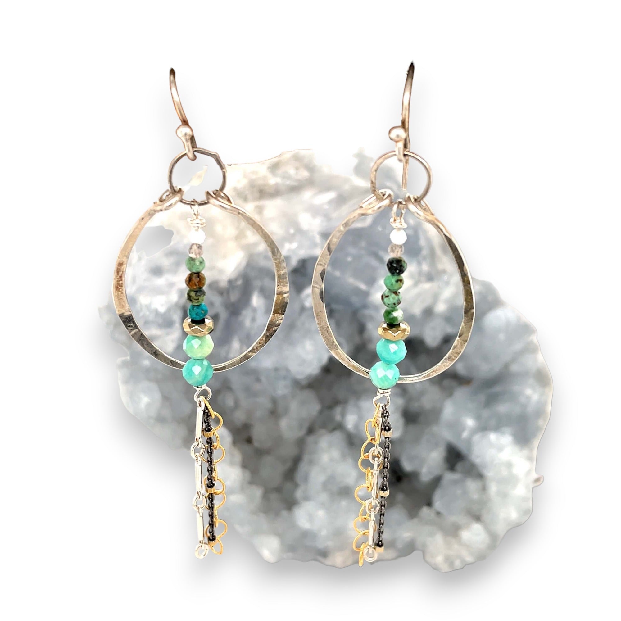 A pair of earrings featuring amazonite, turquoise, moonstone, and pyrite gemstones with gold filled and sterling silver chain shimmys