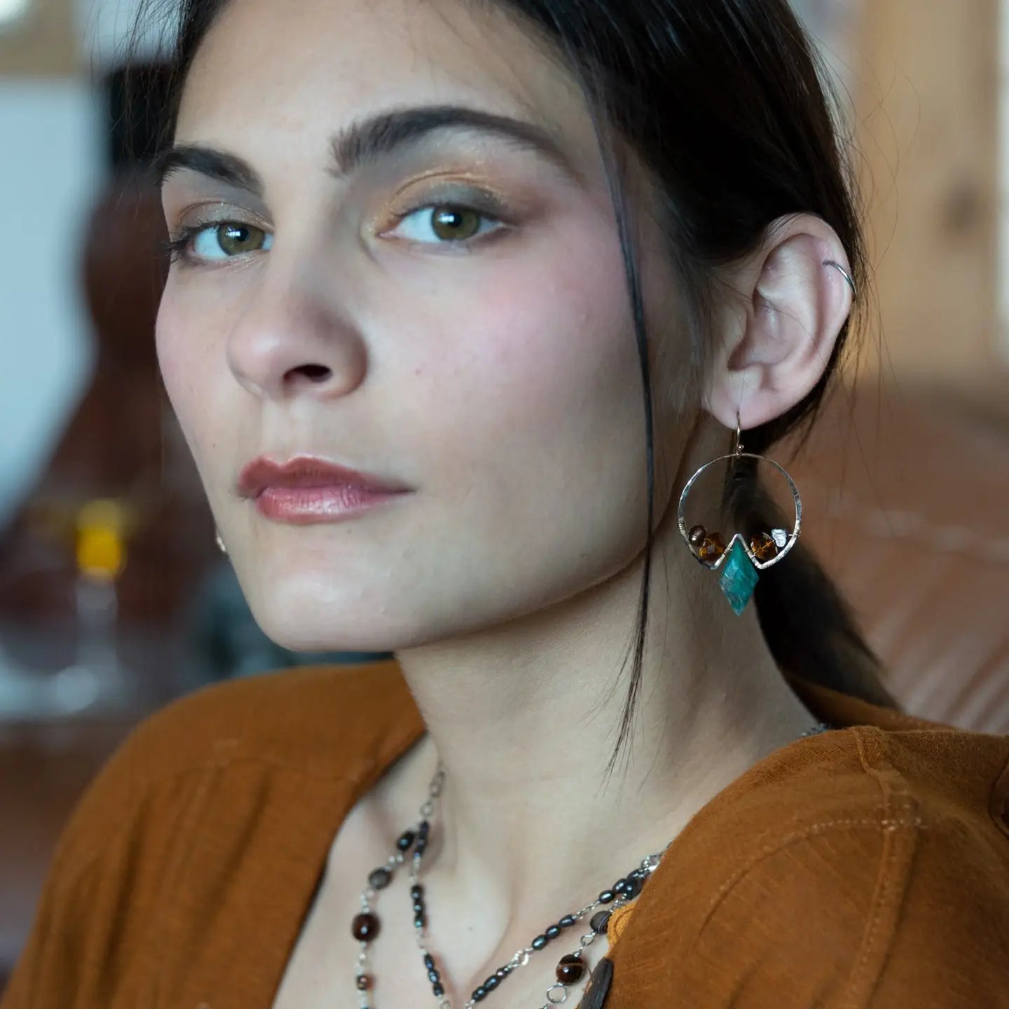 Chrysocolla diamonds are held within bronze hammered hoop earrings with amber crystal and chocolate fresh water pearl accents