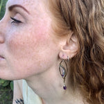 Faceted amethyst drops hang from a brass marquise earring with hammered sterling silver arches and faceted fluorite gemstones