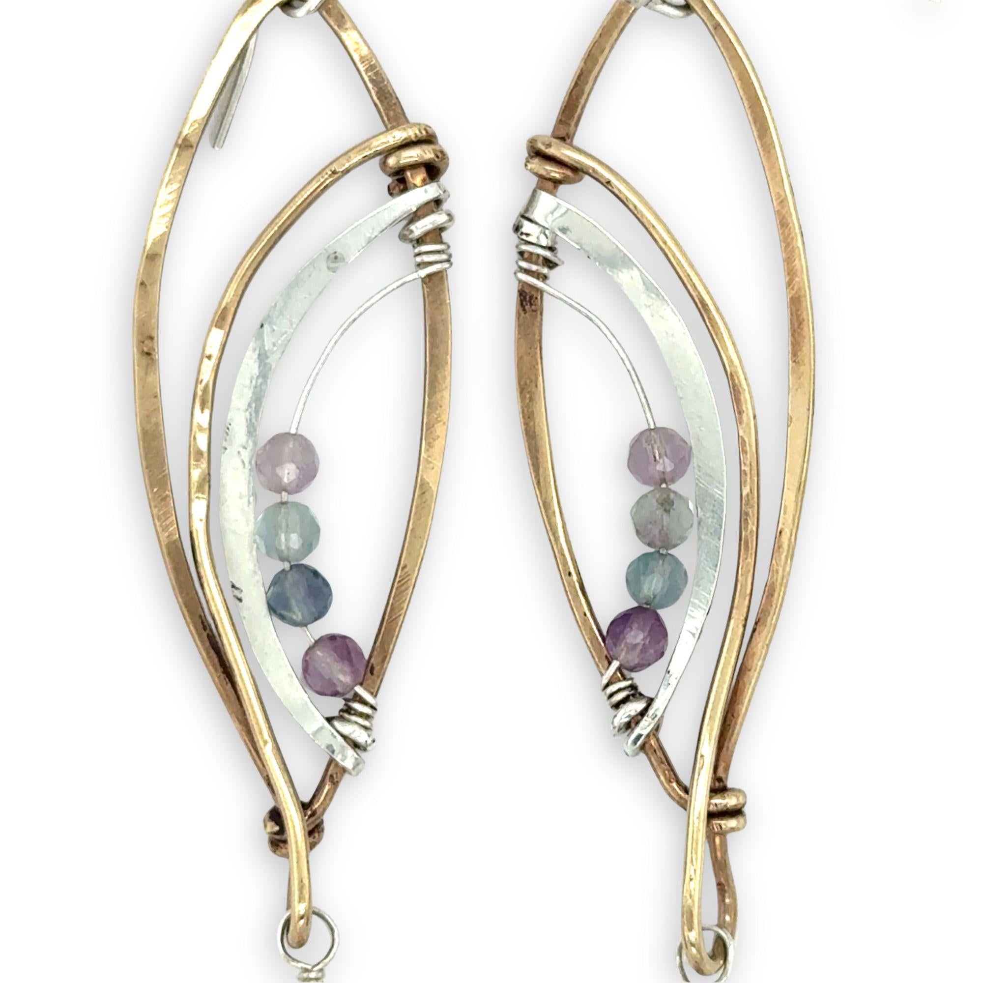 Faceted amethyst drops hang from a brass marquise earring with hammered sterling silver arches and faceted fluorite gemstones