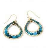 A pair of brass channel hoop earrings with blue apatite gemstones, featuring gold-filled French hooks.