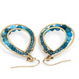 A pair of brass channel hoop earrings with blue apatite gemstones, featuring gold-filled French hooks.