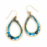 A pair of brass channel hoop earrings with blue apatite gemstones, featuring gold-filled French hooks.