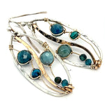 A garden of apatite and chrysocolla gemstones held in veins of gold filled wire attached to a mini handmade sterling silver oval earring with bronze swish accent