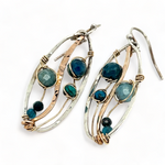 A garden of apatite and chrysocolla gemstones held in veins of gold filled wire attached to a mini handmade sterling silver oval earring with bronze swish accent