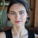 A garden of apatite and chrysocolla gemstones held in veins of gold filled wire attached to a mini handmade sterling silver oval earring with bronze swish accent