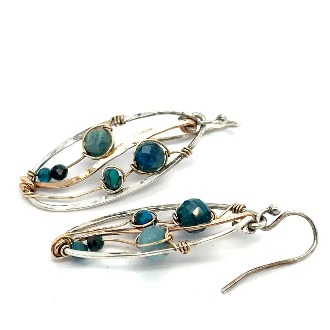 A garden of apatite and chrysocolla gemstones held in veins of gold filled wire attached to a mini handmade sterling silver oval earring with bronze swish accent