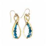 A pair of hammered brass infinity earrings with blue apatite and opal faceted gemstones on gold filled wire