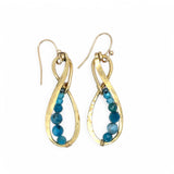 A pair of hammered brass infinity earrings with blue apatite and opal faceted gemstones on gold filled wire