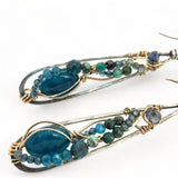 Apatite gemstones accented with blue quartz, chrysocolla, crystal, and bright apatite gemstones wrapped in bronze and gold filled wire inside darkened sterling silver long drop earrings