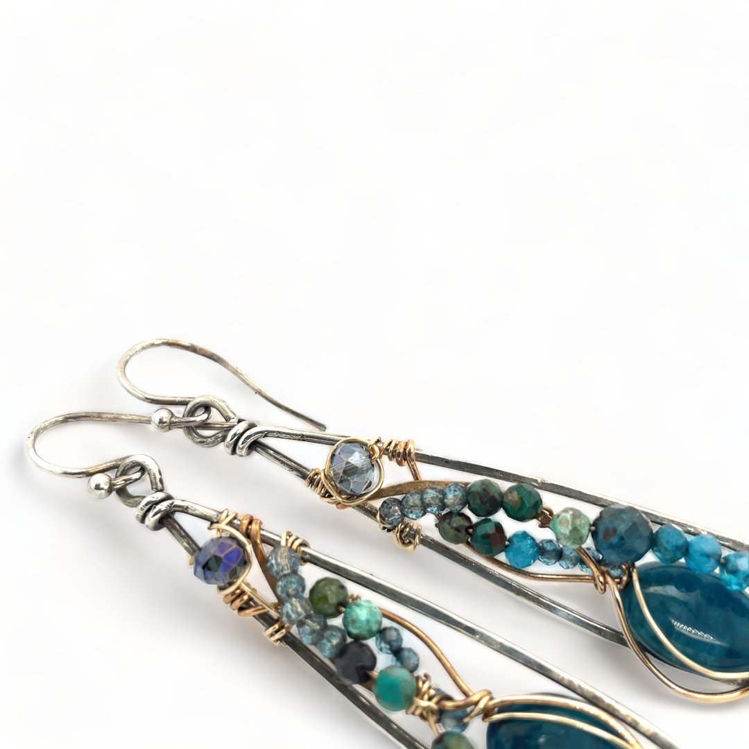 Apatite gemstones accented with blue quartz, chrysocolla, crystal, and bright apatite gemstones wrapped in bronze and gold filled wire inside darkened sterling silver long drop earrings