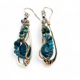 Apatite gemstones accented with blue quartz, chrysocolla, crystal, and bright apatite gemstones wrapped in bronze and gold filled wire inside darkened sterling silver long drop earrings