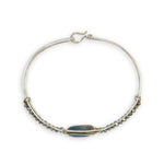 Sterling silver slim bracelet with a smooth apatite tile center surrounded by hammered brass and pyrite gemstone accents