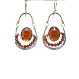 Red/orange oval crystal and hessonite garnet gemstones sit inside a hammered sterling silver and bronze hoop earring