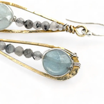 Aquamarine coins and black tourmaline quartz faceted gemstones in brass drop earrings with sterling silver wire.